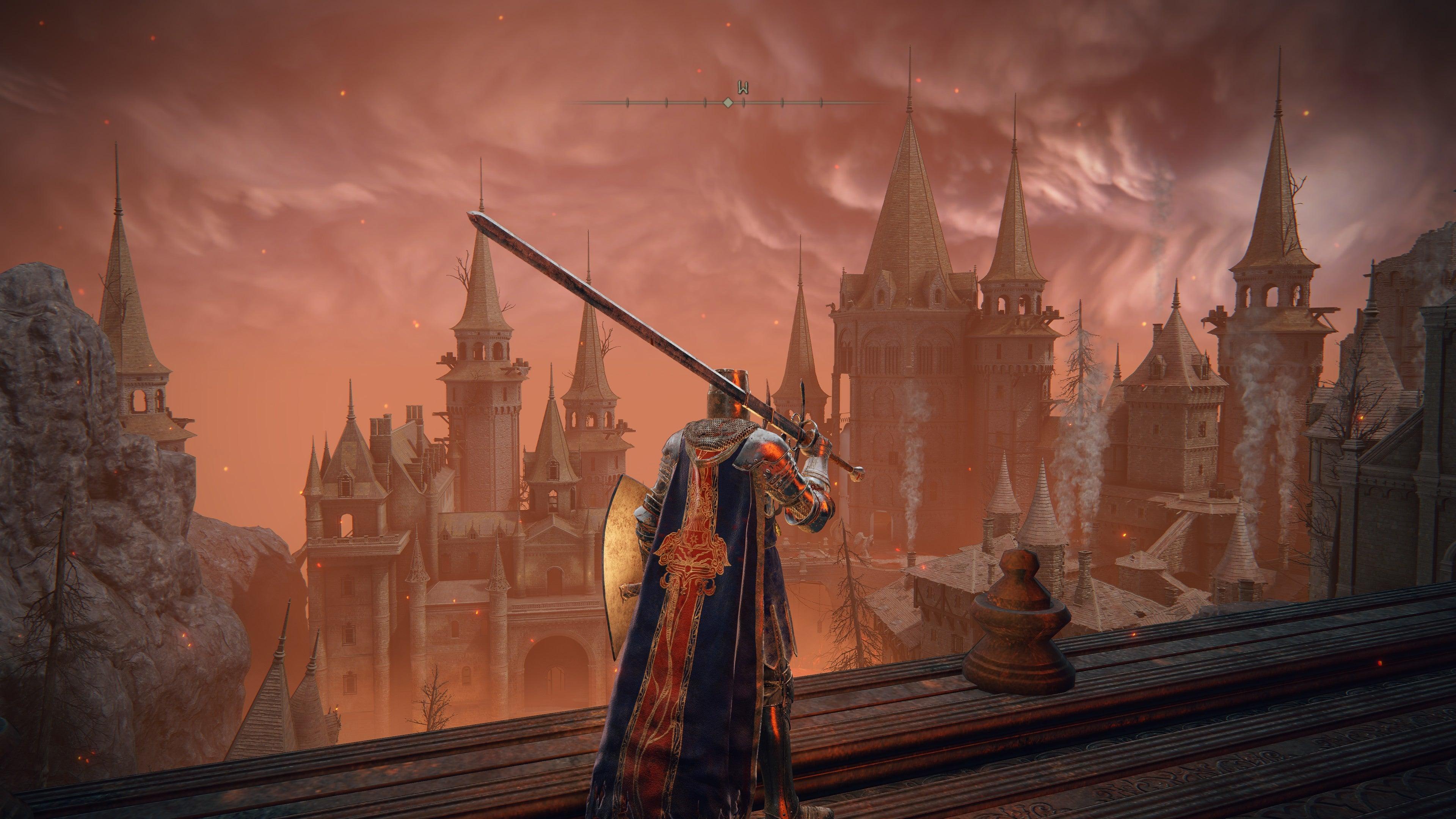 The player in Elden Ring, dressed in Knight's armour, stands with their back to the camera on the edge of a wall overlooking Volcano Manor.