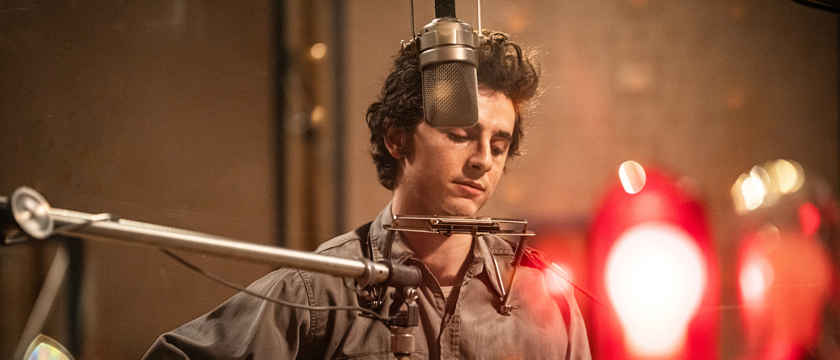 Timothée Chalamet embodies Bob Dylan in a studio scene from A Complete Unknown